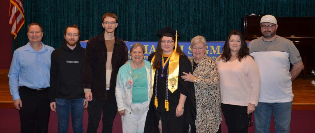 graduate standing with family