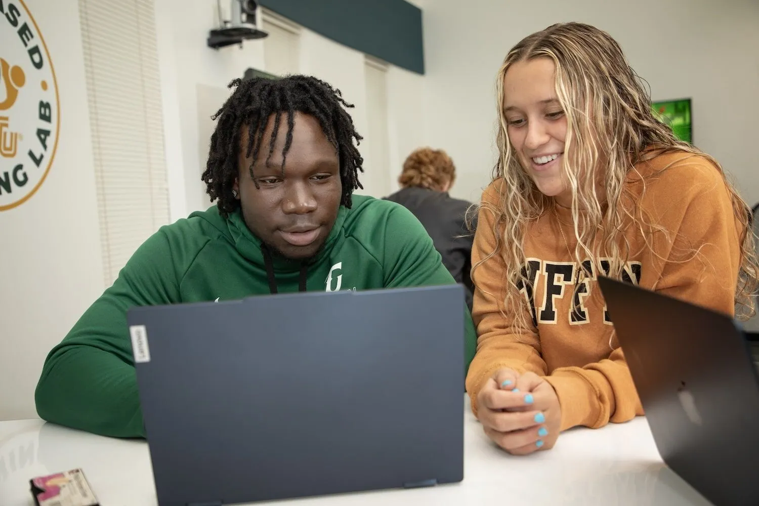 students researching on laptop