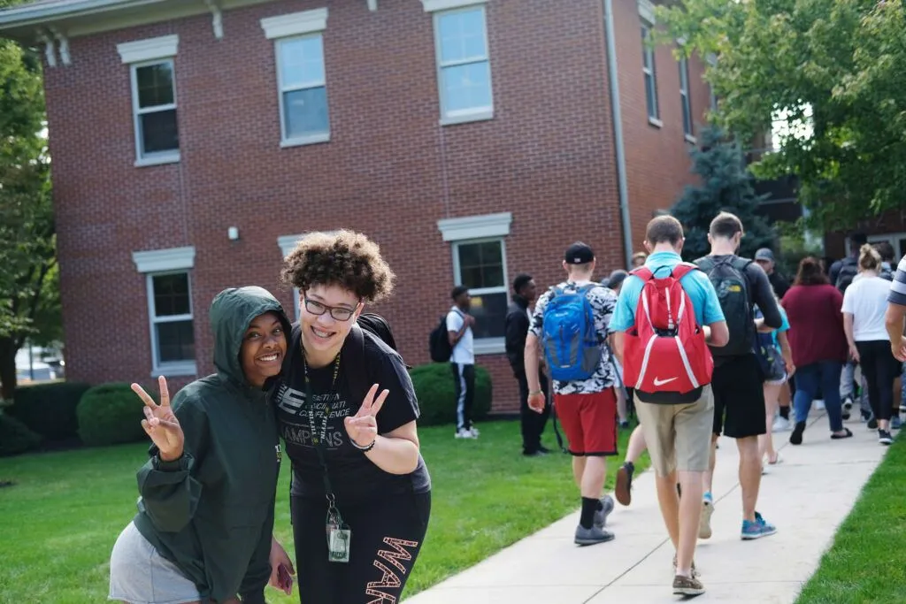 students posing with peace signs