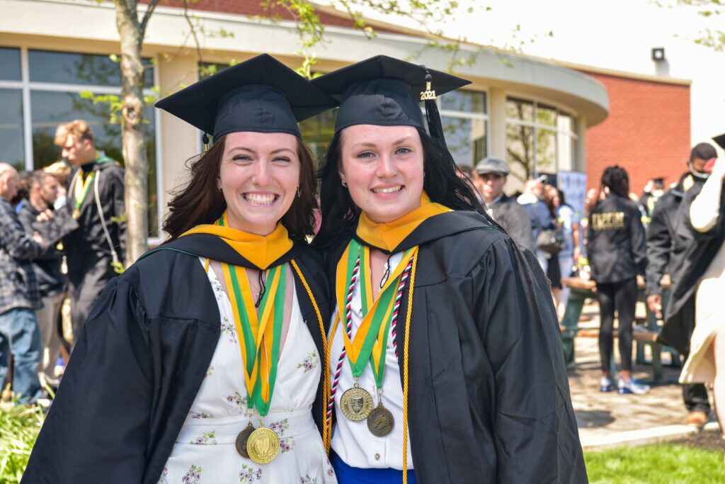 graduates outside with honors