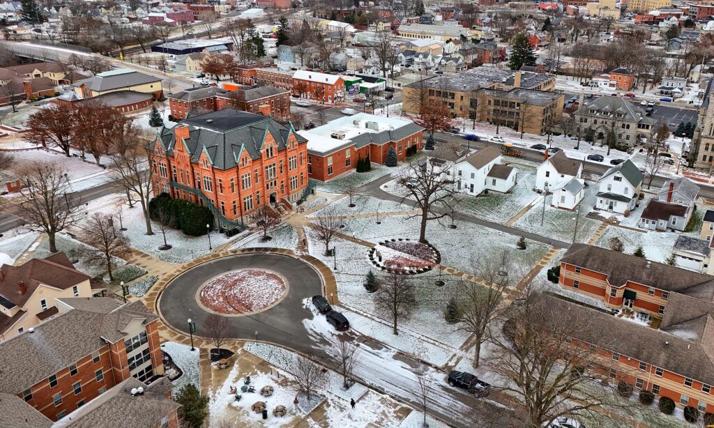 a photo of campus taken by a drone with light snow cover