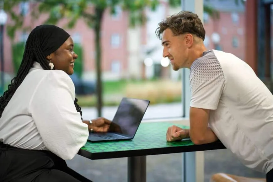 two students talking at heminger center