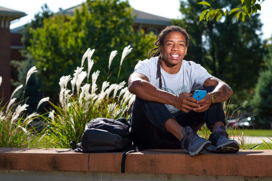 college student holding phone
