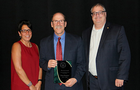 faculty award recipient with two college leaders