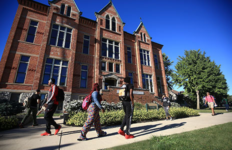 students walking in front of main hall