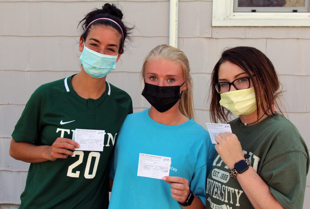 three college students in masks