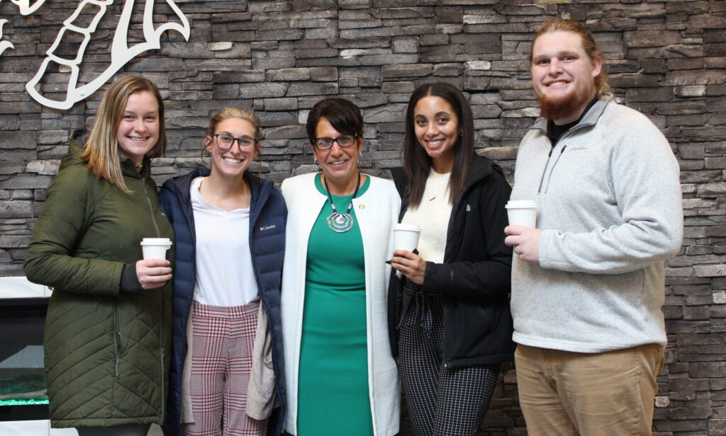 president schumacher with admissions counselors indoors