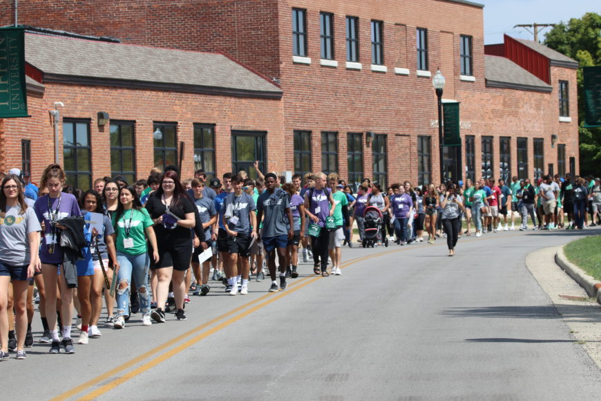 parade of students marching towards convocation