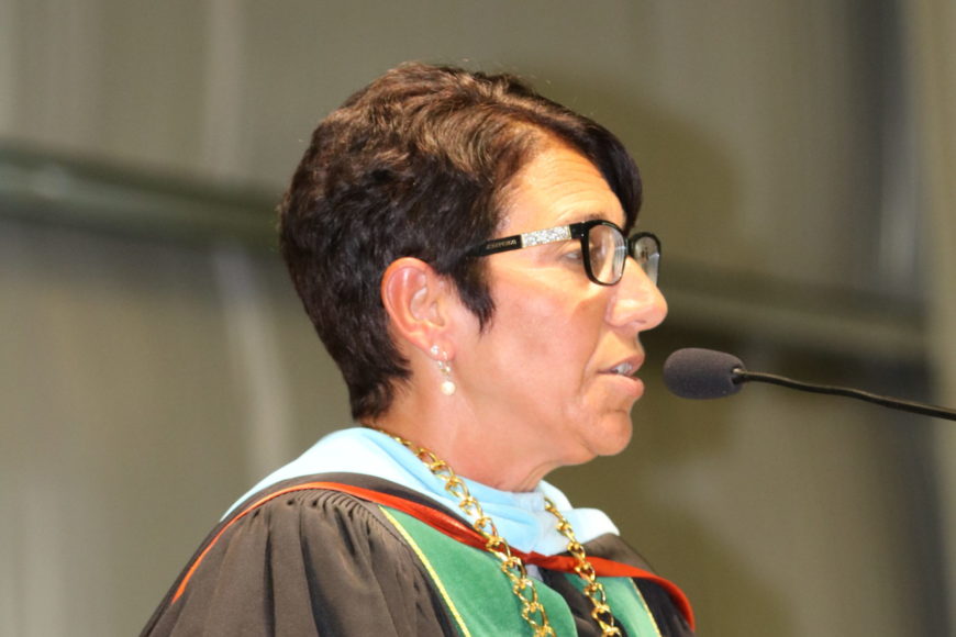 president schumacher at the podium giving a speech