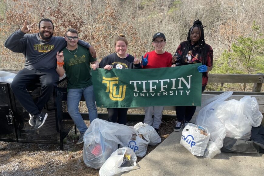 TU Students cleaning up trash outside