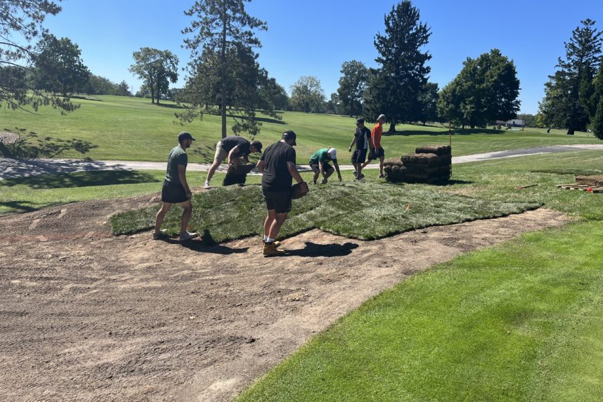 tiffin students laying out grass