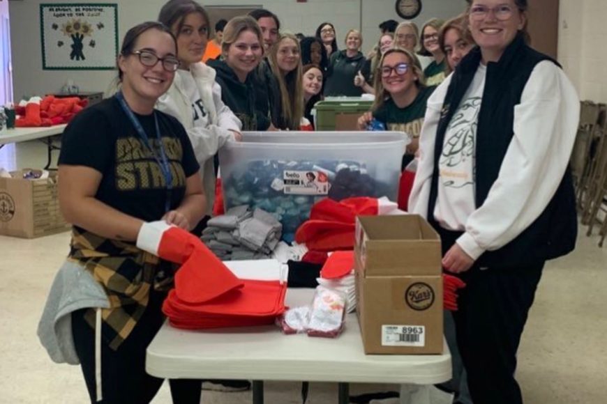 tiffin students smiling packing stockings