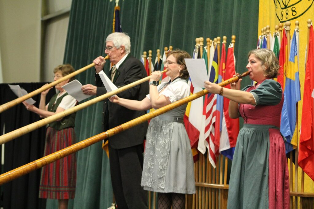 performers playing horns at the international dinner on a stage