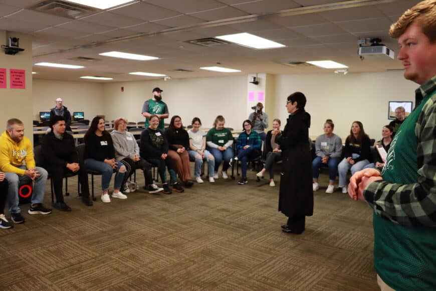 president addressing large group of students