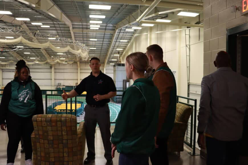 male instructor talking with students at secret service event