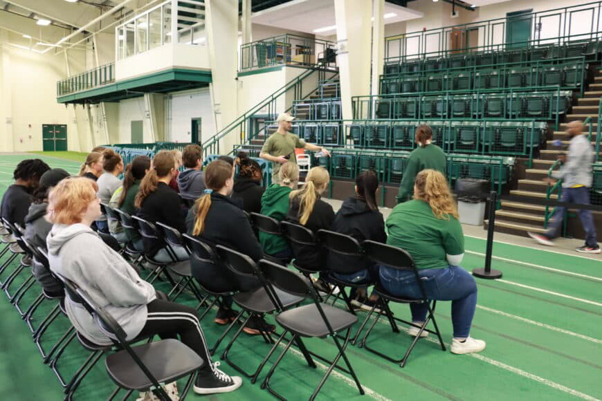 maleinstructor talking with students at secret service event