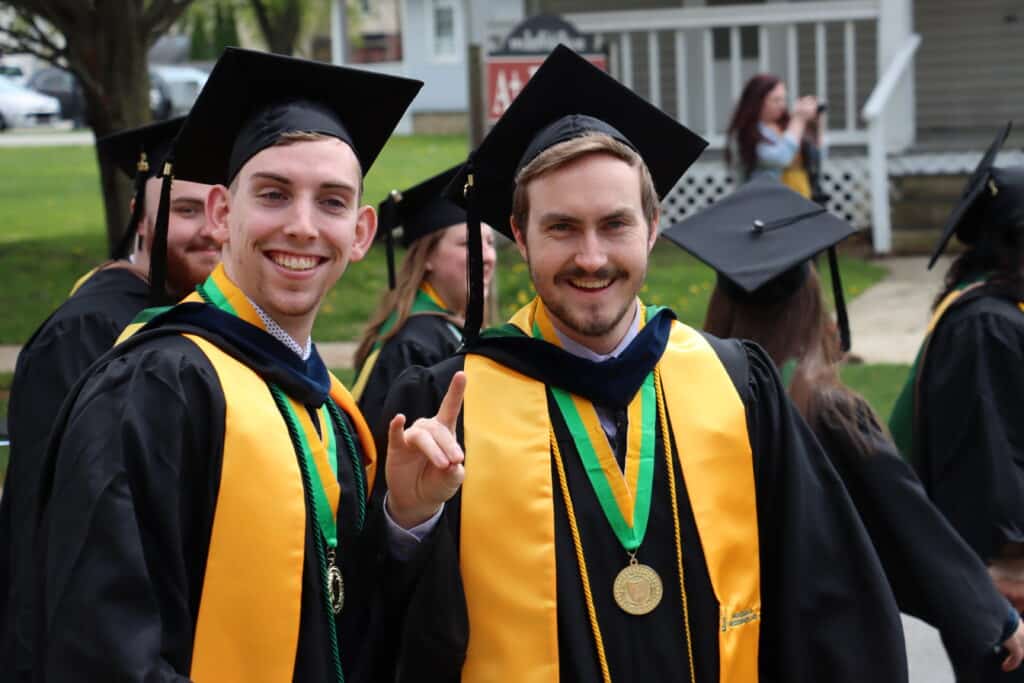 smiling students in cap and gown attire