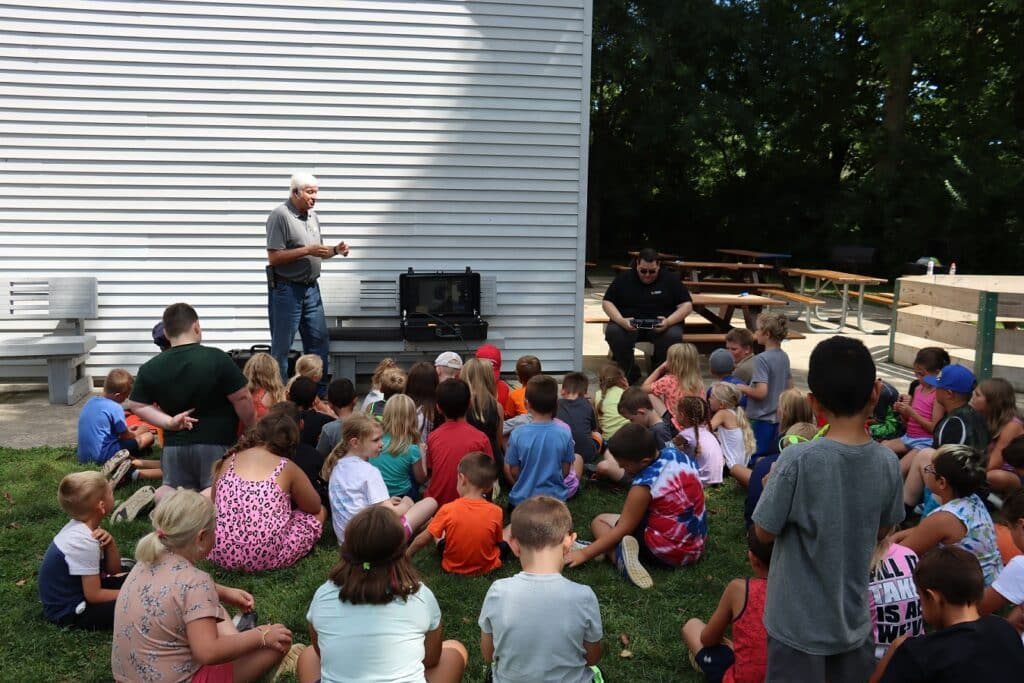 drone instructors talking to a large group of students outside