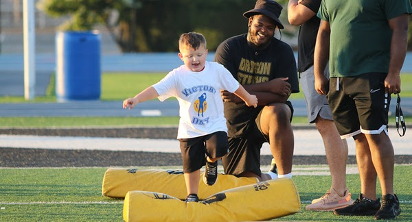 child participating in victory day running outside