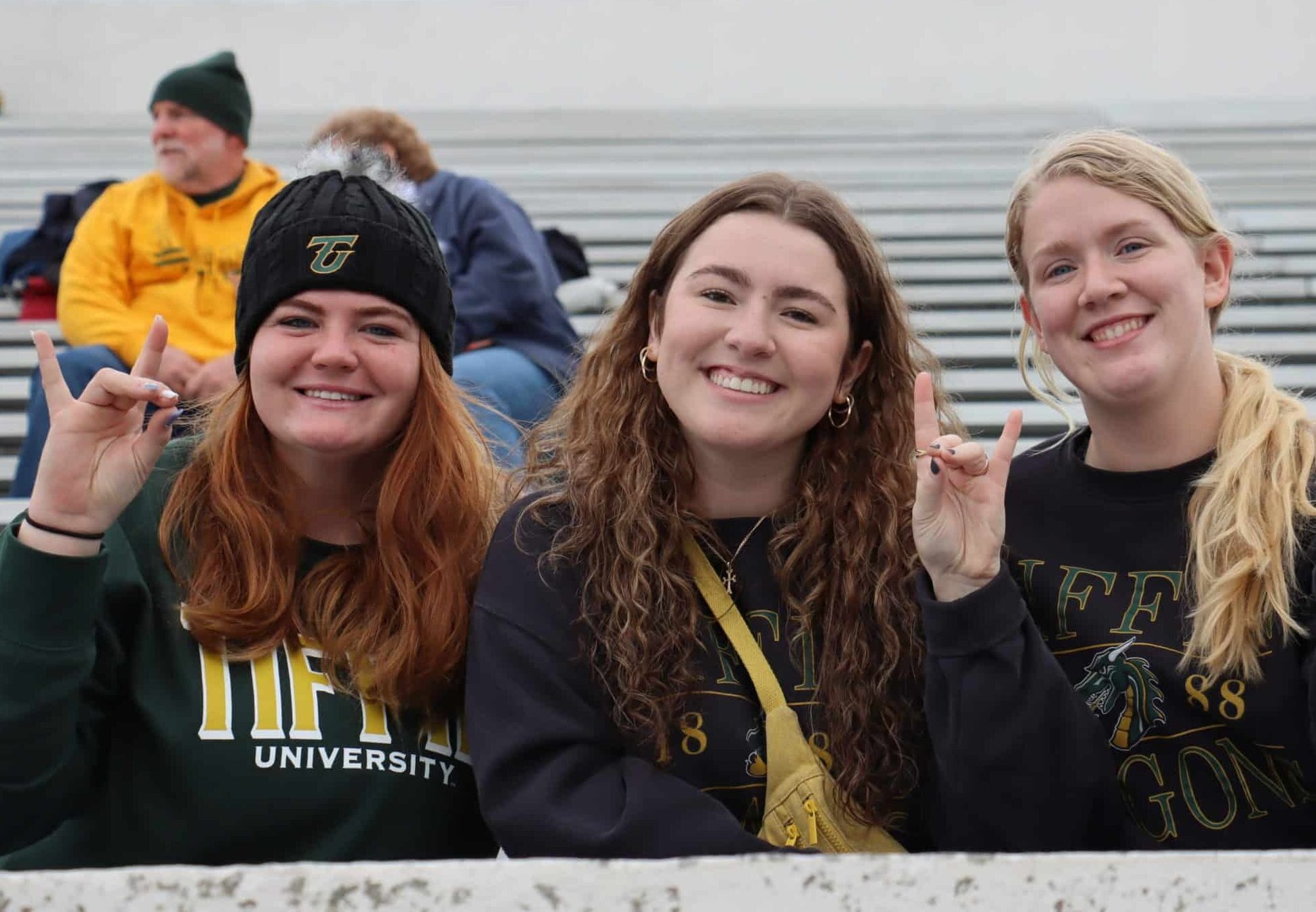 smiling alumni at football game