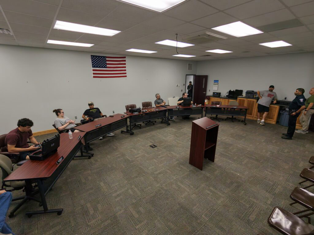 TU's Dragon Flight Fellowship members sitting in a room at desks
