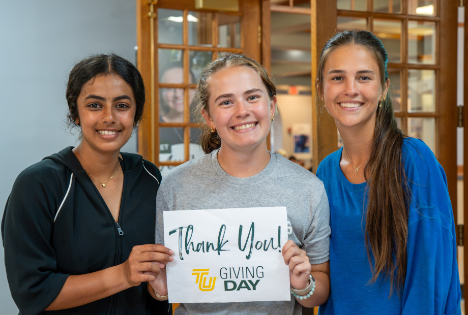 Photo of three students holding thank you sign