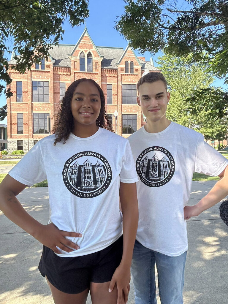 students posing in 2026 impact shirt