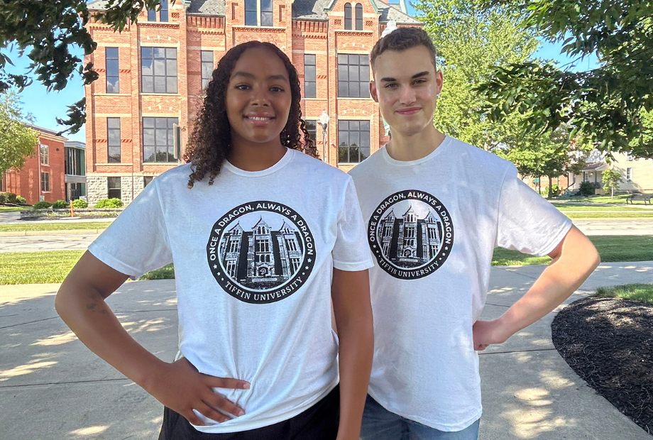 two students wearing the 2026 impact shirt