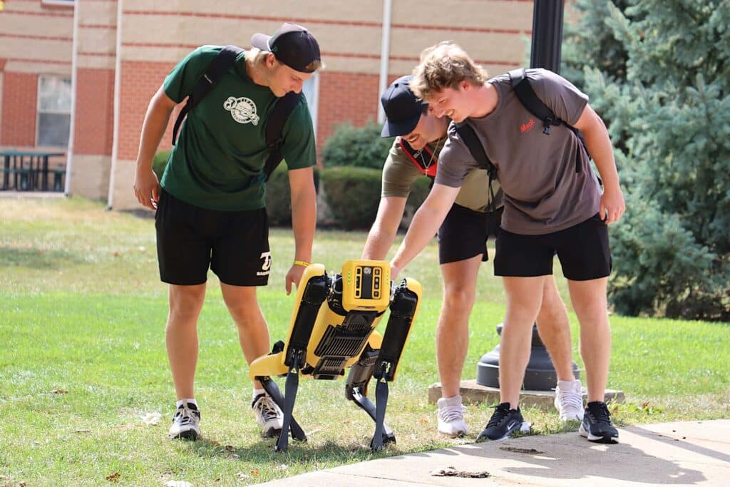 Robotic dog, spot, on campus with AI minor students