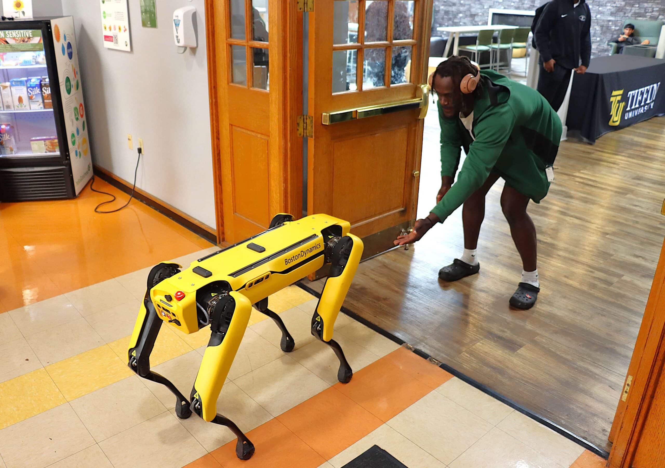 student greeting ai robotics dog, spot
