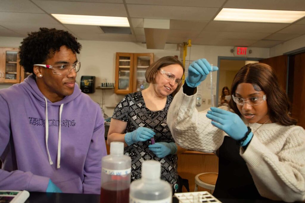 Students with professor in lab