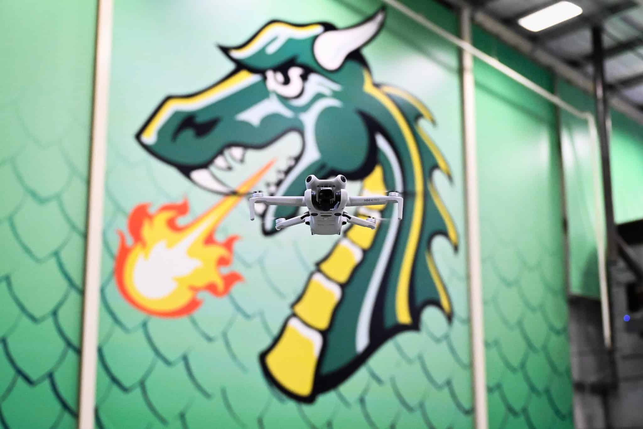 drone flying near dragon mural