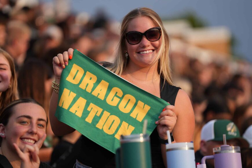 football fan holding dragon nation banner