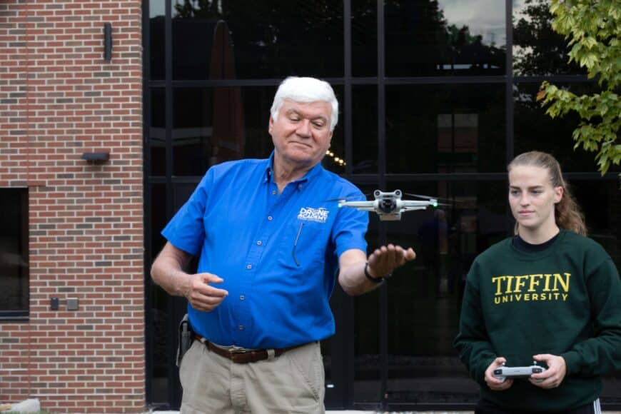 professor and grad assistant flying drone