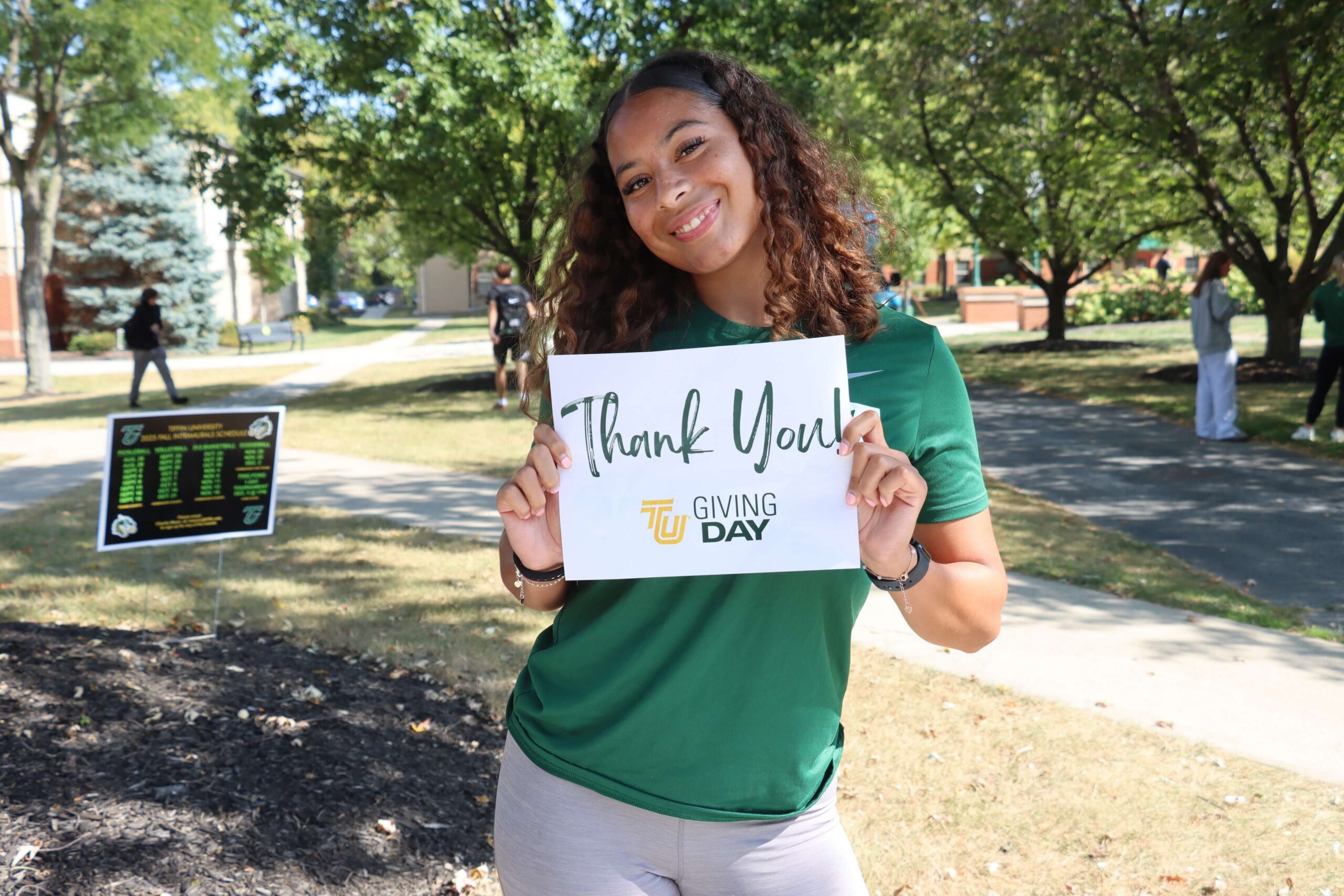 student holding thank you sign