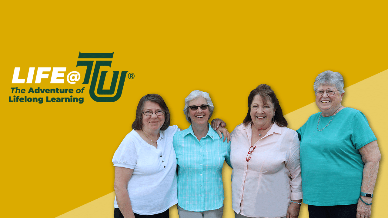 ladies smiling with a yellow background