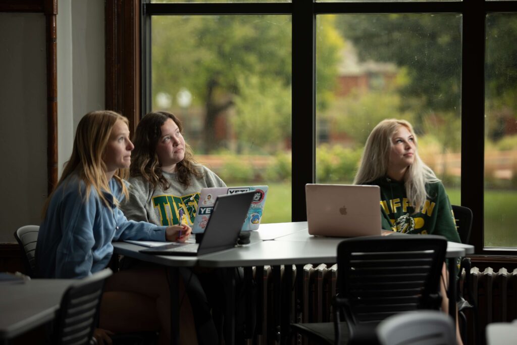 Digital media students in class with their laptops