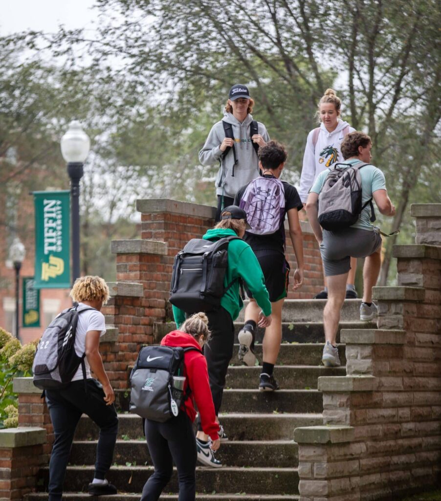 students walking up steps of main