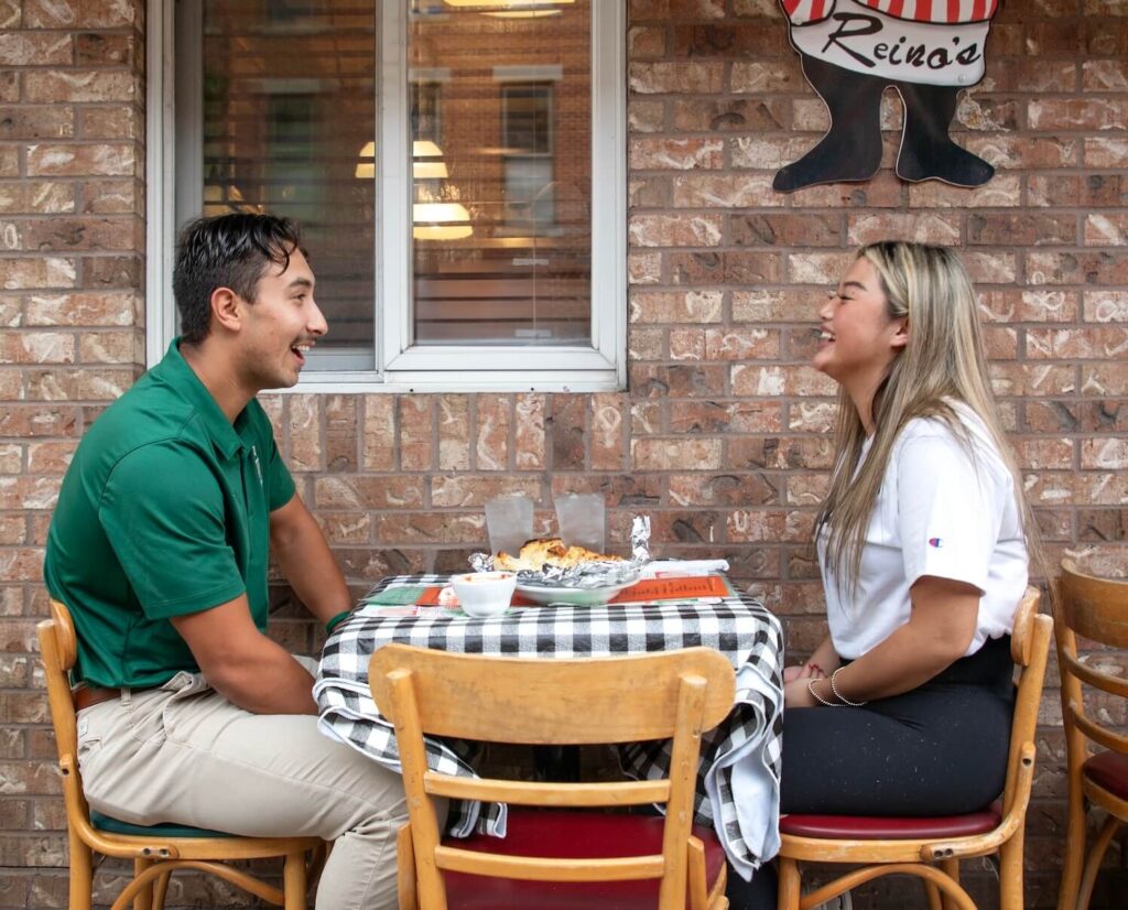 TU students eating pizza at a restaurant in Tiffin, Ohio