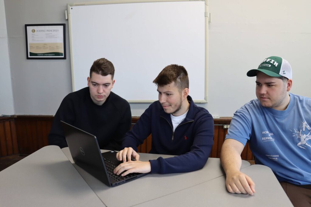 business strategy game team at laptop