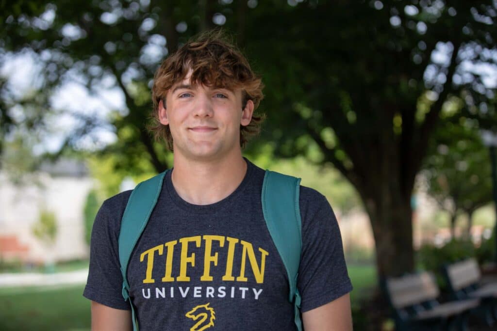 TU student standing under a tree